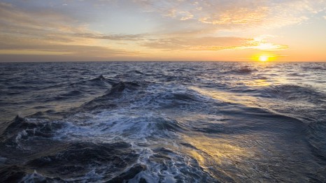 Golden sunrise clouds and rising sun above sea , Atlantic Ocean